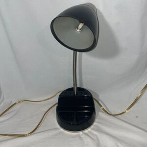 Desk lamp with outlet and slots for office supplies